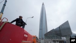 FILE - A worker sits on his water tank truck next to the business tower Lakhta Centre, the headquarters of Russian gas monopoly Gazprom in St. Petersburg, Russia, on April 27, 2022. Gazprom said on Dec. 28, 2024, it would suspend gas exports to Moldova on Jan. 1.