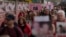 FILE: Family members of those who died of COVID walk past the National Covid Memorial wall in London, Tuesday, March 29, 2022. 