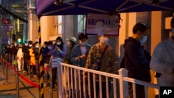 FILE - Residents line up for COVID test in Shanghai, China, March 29, 2022.