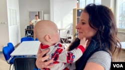 Texan mother-of-four Katie Stadler, a 38-year-old, says, "These kids and these families that are coming out need to see that humanity is still good and people are still good." (Jamie Dettmer/VOA)