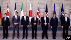 From left, Japan's PM Fumio Kishida, Canada's PM Justin Trudeau, U.S. President Joe Biden, Germany's Chancellor Olaf Scholz, British PM Boris Johnson, France's President Emmanuel Macron, Italy's PM Mario Draghi in a G7 leaders' group photo in Brussels, March 24, 2022.