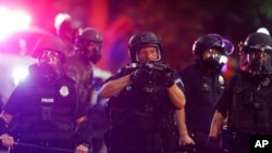 FILE — Police use tear gas and rubber bullets to disperse a protest outside the State Capitol in Denver, Colorado, May 28, 2020.
