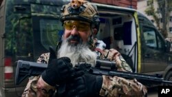 A Ukrainian soldier smiles and gives a thumbs-up in Bakhmut, in Ukraine's Donetsk region, Nov. 11, 2022.