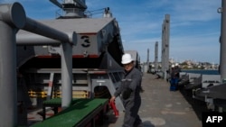FILE - A U.N. official inspects the Barbados-flagged ship Nord Vind coming from Ukraine, loaded with grain and anchored in Istanbul, Oct. 11, 2022.