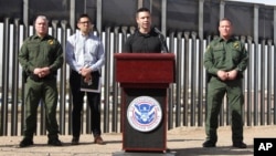 Customs and Border Protection Commissioner Kevin McAleenan (C) announced that the Trump administration will temporarily reassign several hundred border inspectors during a news conference at the border in El Paso, Texas, March 27, 2019.