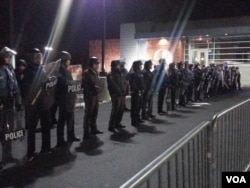 Ferguson police behind barricades before they came forward and arrested between 4-6 people, Nov. 19, 2014. (Ayesha Tanzeem/VOA)