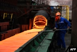 A worker sorts hot red steel at a plant in Zouping in China's eastern Shandong province, March 5, 2018. “China won’t allow itself to be trampled upon," said a recent editorial in an official Chinese newspaper after the Trump administration slapped import tariffs on steel and aluminium.