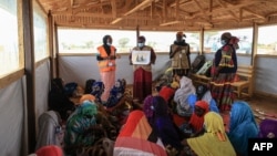 FILE - Women and young girls attend a class in Maroua, Cameroon, on April 28, 2022. Some 30,000 Cameroonian women took to the streets in Yaounde on International Women's Day, March 8, 2024, to call for educational, economic and social equality.