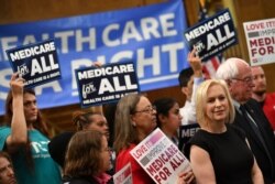 FILE - Democratic 2020 presidential hopefuls Sen. Kirsten Gillibrand (D-NY) and Bernie Sanders (I-VT) attend a Medicare For All event on Capitol Hill in Washington, April 10, 2019.