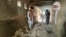 People inspect the inside of a mosque following a suicide bombers attack in the city of Kandahar, southwest Afghanistan, Oct. 15, 2021.