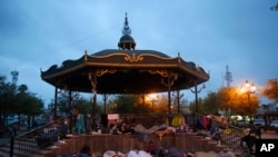 FILE - Migrants sleep under a gazebo in Reynosa, Mexico, March 27, 2021. The camp of migrants mainly from Guatemala, El Salvador, Honduras and Haiti sprung up after U.S. officials. citing the pandemic, invoked a a health rule that denies migrants a chance to seek asylum.