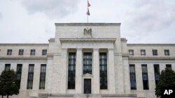 FILE - This May 4, 2021, file photo shows the Federal Reserve building in Washington.