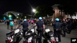 Washington Metropolitan Police form a line outside the Supreme Court, May 3, 2022, in Washington, after a draft opinion circulated among Supreme Court justices suggests that a majority supported overturning the 1973 decision that legalized abortion nationwide.