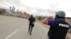 FILE - AP photojournalists John Minchillo and Julio Cortez cover continued demonstrations in reaction to the death in Minneapolis police custody of George Floyd, in Minneapolis, Minn., May 31, 2020.