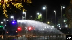 Police use water cannons to disperse protesters, March 20, 2021, in Bangkok, Thailand. Thailand's student-led pro-democracy movement held a rally in the Thai capital, seeking to press demands that include freedom for their leaders.