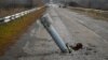A tail of a rocket sticks out of the ground near the recently recaptured village of Zakitne, Ukraine, Nov. 9, 2022. 