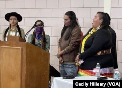 Indigenous Youth Council members pray during a ceremony marking the return of sacred artifacts to the Lakota, Sat. Nov. 5, 2022, Barre Mass.