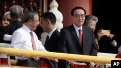 Chen Quanguo, right, Communist Party secretary of China's Xinjiang Uighur Autonomous Region, is one of the four Chinese officials the United States has imposed sanctions.