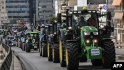 Greek farmers drive their tractors as they gather during a protest against shrinking incomes, rising costs and what they say are increasingly onerous environmental rules, in Athens on Feb. 20, 2024.