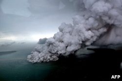 This aerial picture taken on Dec. 23, 2018 by Bisnis Indonesia shows the Anak (Child) Krakatoa volcano erupting in the Sunda Straits off the coast of southern Sumatra and the western tip of Java.