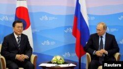 Russian President Vladimir Putin and his South Korean counterpart Moon Jae-in attend a meeting during the Eastern Economic Forum in Vladivostok, Russia, Sept. 6, 2017. 