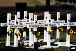 Crosses with the names of Tuesday's shooting victims are placed outside Robb Elementary School in Uvalde, Texas, May 26, 2022.