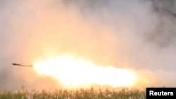 FILE - US military forces fire a High Mobility Artillery Rocket System (HIMARS) rocket during the annual Philippines-US live fire amphibious landing exercise (PHIBLEX) at Crow Valley in Capas, Tarlac province, north of Manila, Philippines, Oct. 10, 2016.