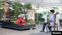 Presidential candidate Ferdinand 'Bongbong' Marcos Jr. visits the grave of his father former President Ferdinand E. Marcos, at Libingan ng mga Bayani, Taguig, May 10, 2022, in this handout picture released May 11, 2022. (BBM Official Page/Handout via Reuters)