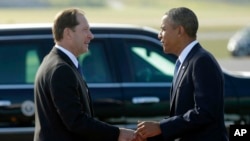 FILE - In this Sept. 4, 2013, file photo President Barack Obama, right, is greeted by U.S. Ambassador Mark Brzezinski, left, upon his arrival at Stockholm-Arlanda International Airport in Stockholm, Sweden.