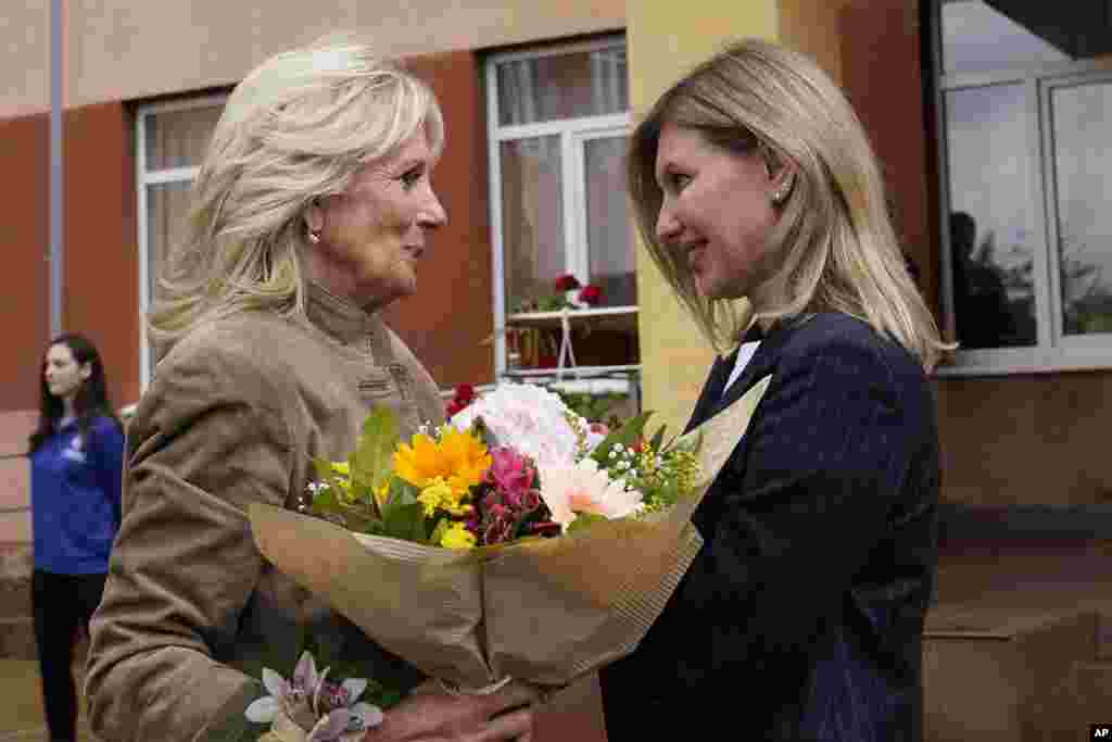 U.S. First Lady Jill Biden greets Olena Zelenska, wife of Ukrainian President Volodymyr Zelenskyy, outside of School 6, a public school that has taken in displaced students in Uzhhorod, Ukraine.