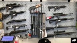 FILE - In this Feb. 19, 2021, photo, firearms are displayed at a gun shop in Salem, Ore.