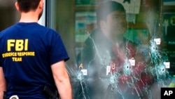 Investigators work the scene of a shooting at a supermarket, in Buffalo, N.Y., May 16, 2022.