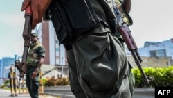 Soldiers stand guard at a check point in Colombo on May 11, 2022.
