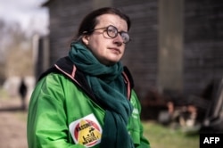 FILE - Director General of Oxfam France Cecile Duflot looks on during a gathering against the first mega-retention pond project near the pond in Mauze-sur-le-Mignon, Western France, Feb. 23, 2022.