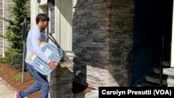 Ismail Khan, on behalf of the Afghans of Puget Sound Alliance, carries donated supplies to the home of a widow with eight children. Her husband worked with U.S. Special Forces and was killed in a suicide bomb in 2021.Photo Credit: Carolyn Presutti