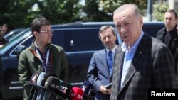 Turkish President Recep Tayyip Erdogan talks to media as he leaves a mosque after Friday prayers in Istanbul, Turkey, May 13, 2022.
