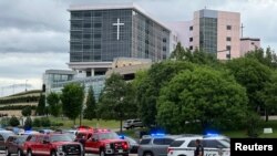 Emergency personnel work at the scene of a shooting at the Natalie Medical Building in Tulsa, Okla., June 1, 2022. 