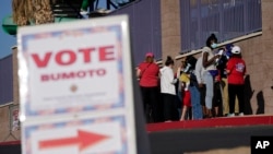 FILE - People wait in line to vote at a polling station on election day in Las Vegas, Nevada, Nov. 3, 2020.