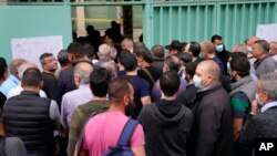 People line up to vote during parliamentary elections in Beirut, Lebanon, May 15, 2022. 
