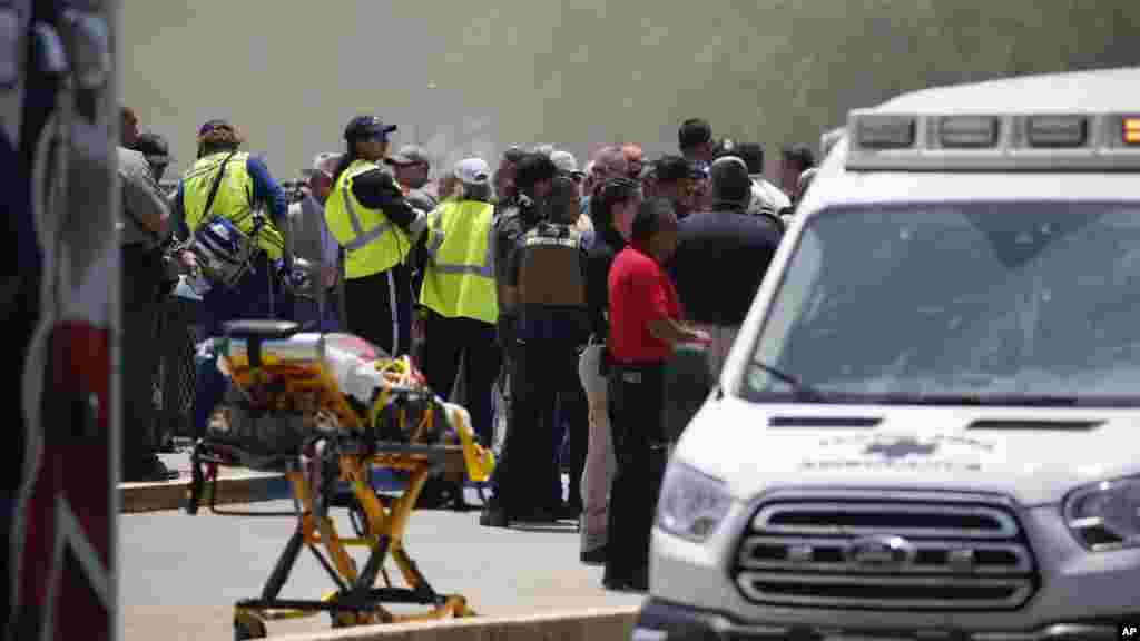 Emergency personnel gather near Robb Elementary School following a shooting, May 24, 2022, in Uvalde, Texas.