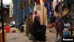 FILE - People who fled attacks by Islamist militants in northern Burkina Faso are seen at a camp for internally displaced people in Ouagadougou, Burkina Faso, Jan. 29, 2022. 