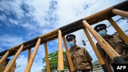 Police stand guard near the parliament building in Colombo, Sri Lanka, May 17, 2022.