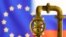 A model of the natural gas pipeline is seen in front of displayed word EU and Russia flag colours in this illustration taken March 8, 2022. 