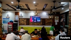 FILE - Chinese President Xi Jinping speaks via video link at the opening ceremony of the 2021 China International Fair for Trade in Services in Beijing, at a restaurant in Shanghai, China, Sept. 2, 2021.