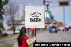 Native American woman participating in NDN Collective protest against racist businesses in Rapid City, S.D., April 20, 2022.