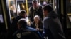 A woman who fled from the Azovstal steel plant in Mariupol is helped from a bus upon her arrival at a reception center for displaced people in Zaporizhzhia, Ukraine, May 8, 2022. 