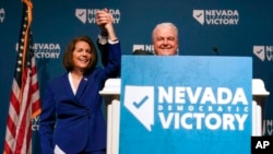 Sen. Catherine Cortez Masto, D-Nev., left, reacts alongside Nevada Gov. Steve Sisolak during an election night party hosted by the Nevada Democratic Party, Nov. 8, 2022, in Las Vegas. 