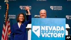 Sen. Catherine Cortez Masto, D-Nev., left, reacts alongside Nevada Gov. Steve Sisolak during an election night party hosted by the Nevada Democratic Party, Nov. 8, 2022, in Las Vegas. 