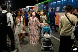 People queue to leave the COP27 U.N. Climate Summit, in Sharm el-Sheikh, Egypt, Nov. 14, 2022.