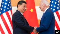 U.S. President Joe Biden, right, and Chinese President Xi Jinping shake hands before a meeting on the sidelines of the G-20 summit meeting, in Bali, Indonesia, Nov. 14, 2022.